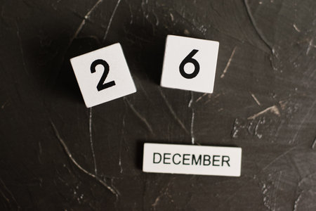 Flatlay, wooden calendar with date December 26 on a dark textured backgroundの写真素材