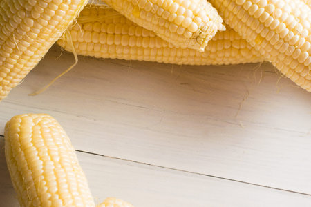Flatlay, delicious, sweet white corn on light table close-up, copy space background.