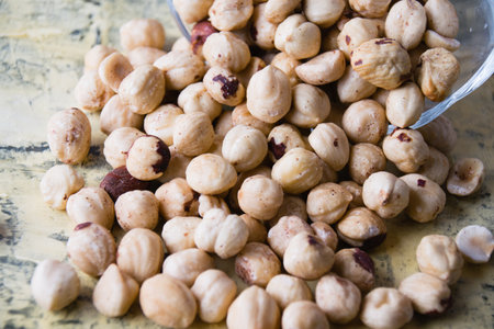 Delicious roasted peeled hazelnuts close-up in a glass bowlの写真素材