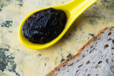 Flatlay, chocolate paste with nuts and white bread with sesame on a light background. Concept of calories and junk food.の写真素材