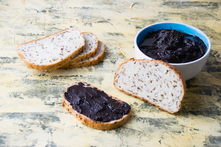 A tasty and nutritious snack of white bread with chocolate paste on a light background. Concept of calories and junk food.の写真素材