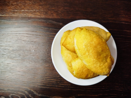 Delicious homemade pies on a plate on a dark wooden table.の写真素材