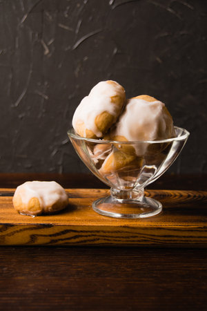 Homemade gingerbread cookies with honey, cinnamon and vanilla in a glass bowl on a dark background.