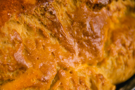 Appetizing crust of freshly baked bread, aroma of butter and milkの写真素材