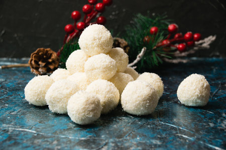Christmas, delicious homemade candies with coconut flakes and almonds on a dark background. Concept of delicious holiday homemade dishesの写真素材