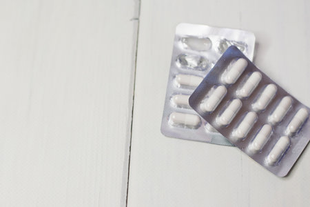 Pills in blister pack on light background with copy space.の写真素材