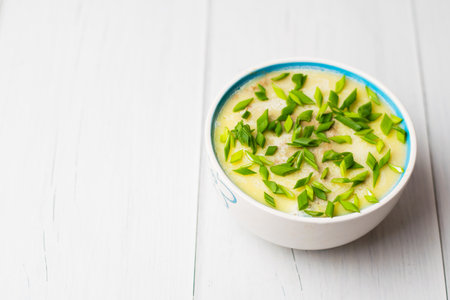 Healthy food, liver pate with green onions in a bowl on a light tableの写真素材