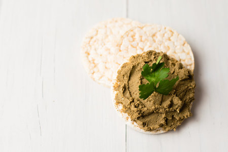 Healthy food, crispy rice cakes and liver pate on a light table