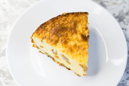 An appetizing and aromatic piece of sweet rice pudding with raisins and vanilla.