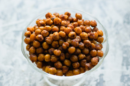 Delicious baked chickpeas in a transparent bowl on a light flatlay background. Healthy eating concept..の写真素材