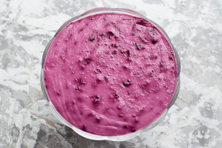 Pink dessert in a transparent bowl on a light background. Summer dessert with currents.の写真素材