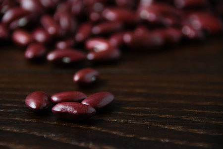 Red beans macro, on a dark wooden table.