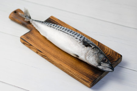 Raw mackerel fish on a cutting board, cooking fish