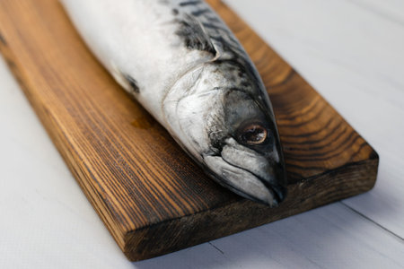 Raw mackerel fish on a cutting board, cooking fish