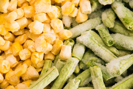Frozen asparagus beans and corn kernels close-up, food background. Food preparation and storage concept.の写真素材
