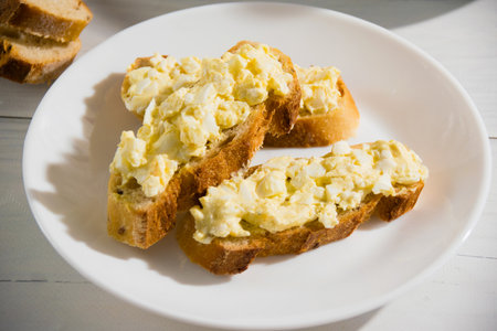 Sandwich with egg and delicious whole grain baguette with sesame seeds. Nutritious breakfast concept.の写真素材