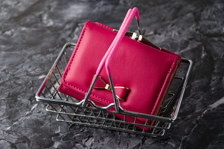 Wallet in a metal shopping basket. Shopping and spending concept.