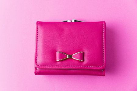 Leather wallet made of artificial leather on a pink background with space for text.の写真素材