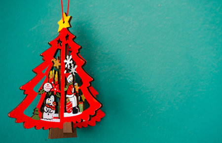 A red christmas tree on the green wall