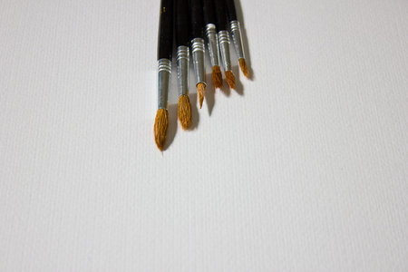 Still life with a set of watercolor painting. Paints, brushes and album with watercolor paper.