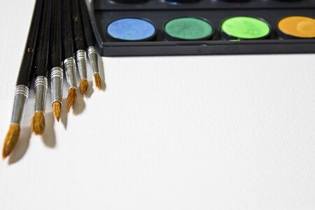 Still life with a set of watercolor painting. Paints, brushes and album with watercolor paper.の写真素材