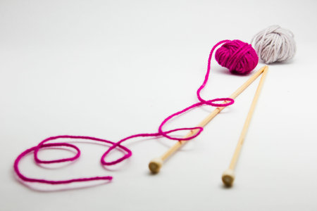 Knitting needles and balls of wool yarn isolated on white background. Knitting accessories for Handmade.の写真素材