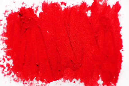 The texture of brush strokes of red lipstick. Background with dabs of red paint.の写真素材