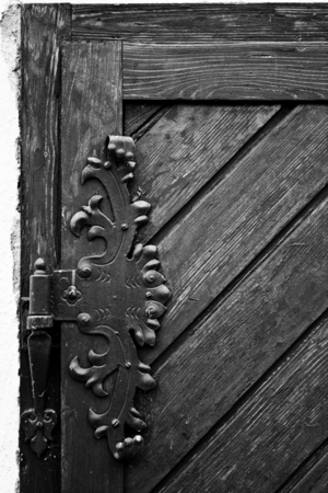 Vintage iron door hinges. Wrought iron hinges on the wooden door.の写真素材