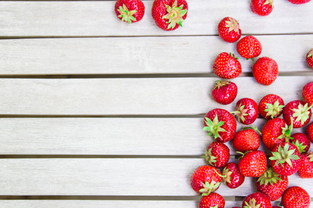 Fresh beautiful strawberries lies on a white wooden table. Natural summer strawberries from the orchard.の写真素材