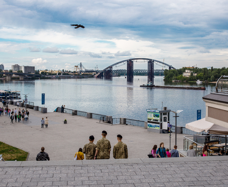 May 25, 2017, Kiev, Ukraine: three soldiers are walking along Poshtova Square. Kiev cityscape with a view of the Dnieper River.のeditorial素材