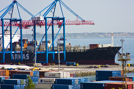 The port in the city of Odessa, Ukraine - May 4, 2017. Cargo containers in the port territory are unloaded by cranes from the ship. Seaport.のeditorial素材
