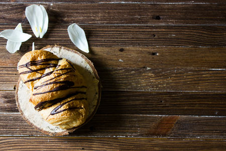 Top view on the table with breakfast: pastries and tea. French croissant with chocolate icing.の写真素材