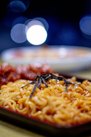 Dry instant noodle in a plate on a dark background.の写真素材