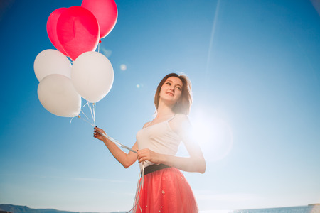 smiling girl with colored balloonsの写真素材