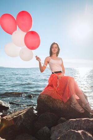 smiling girl with colored balloonsの写真素材