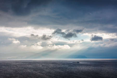Mountains in the rays breaking through the clouds the sunの写真素材