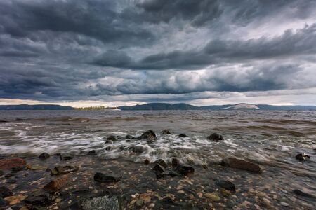 Autumn sea storm with splashes from the waves crashing against the rocksの写真素材