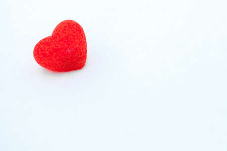 Red textured heart lies on the snow. Valentine's dayの写真素材