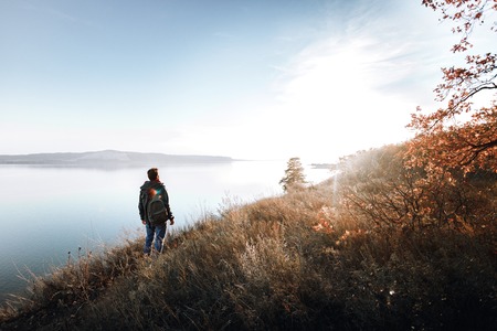 A man on the edge of a cliff in the woodsの写真素材