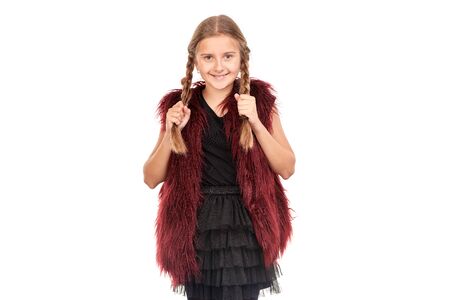 Portrait of little girl with braids posing in Halloween costume against white backgroundの写真素材