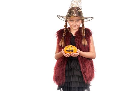 Portrait of little girl with braids posing in Halloween costume against white backgroundの写真素材