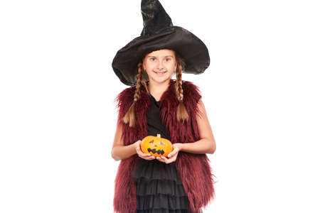 Portrait of little girl with braids posing in Halloween costume against white backgroundの写真素材