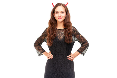 Young woman in Halloween costume posing against white background in studioの写真素材