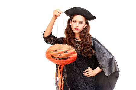 Young woman in Halloween costume posing against white background in studioの写真素材