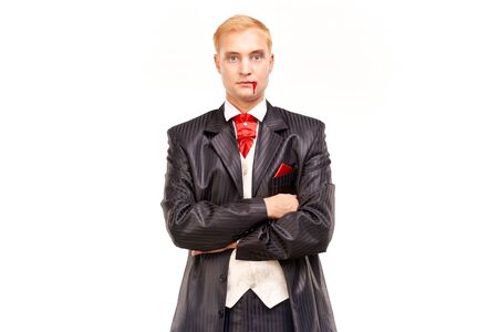 Portrait of handsome young vampire against white backgroundの写真素材