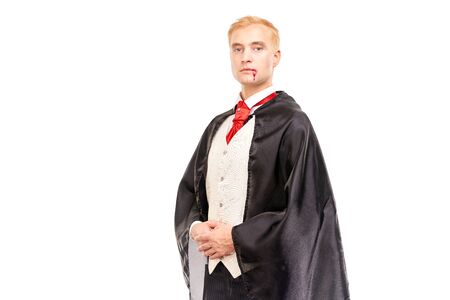 Portrait of elegant vampire with blood on his mouth against white backgroundの写真素材