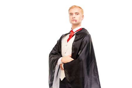 Portrait of elegant vampire with blood on his mouth against white backgroundの写真素材