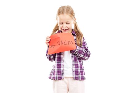Portrait of little girl holding envelope with letter to Santaの写真素材