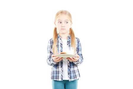 Portrait of beautiful little girl in checked shirt against white backgroundの写真素材