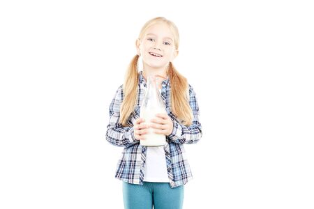 Portrait of beautiful little girl in checked shirt against white backgroundの写真素材